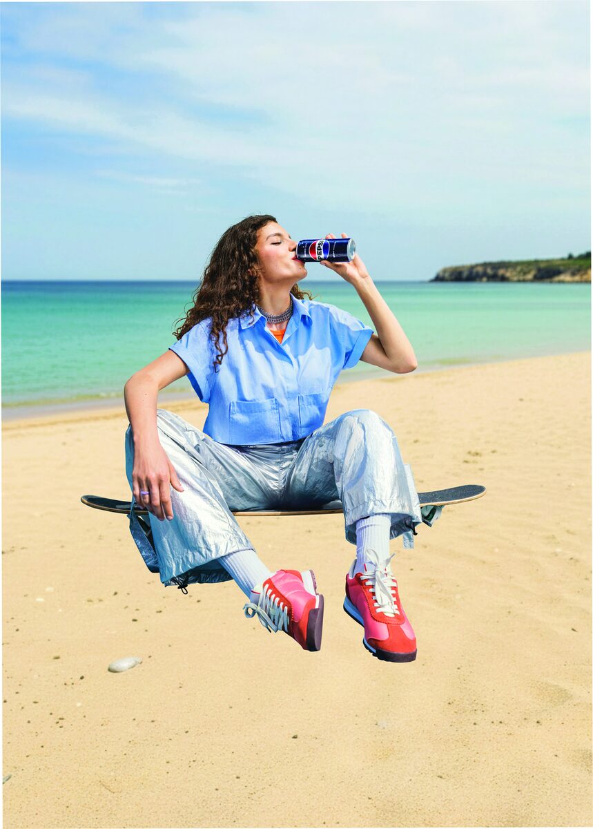 Woman enjoying a Pepsi Zero on the beach